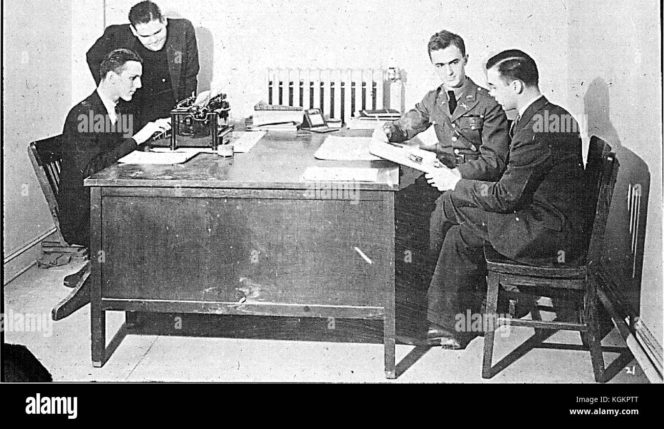 A meeting for the Hullabaloo, the annual yearbook of the Johns Hopkins University in Baltimore, Maryland; four men writing and talking around a typewriter, 1930. Stock Photo