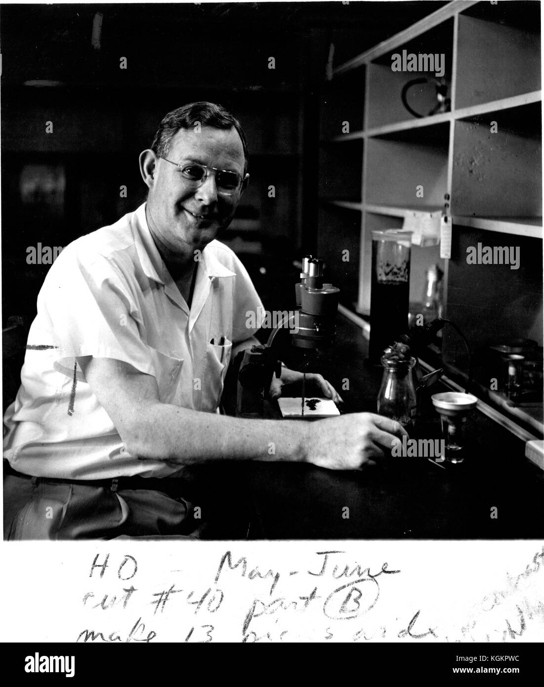 Hiram Bentley, geneticist at the Johns Hopkins University in Baltimore, Maryland, sitting in lab posing with microscope, 1956. () Stock Photo