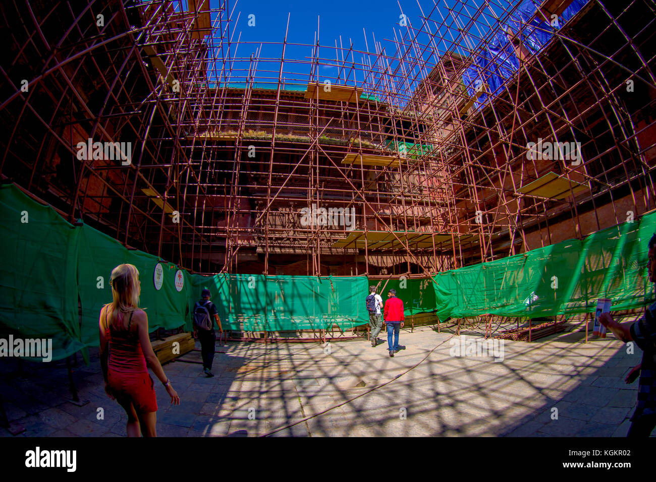 KATHMANDU, NEPAL OCTOBER 15, 2017: Unidentified people walking close to some buildings in reconstruction after the earthquake in 2015 of Durbar square in Kathmandu, capital of Nepal, fish eye effect Stock Photo
