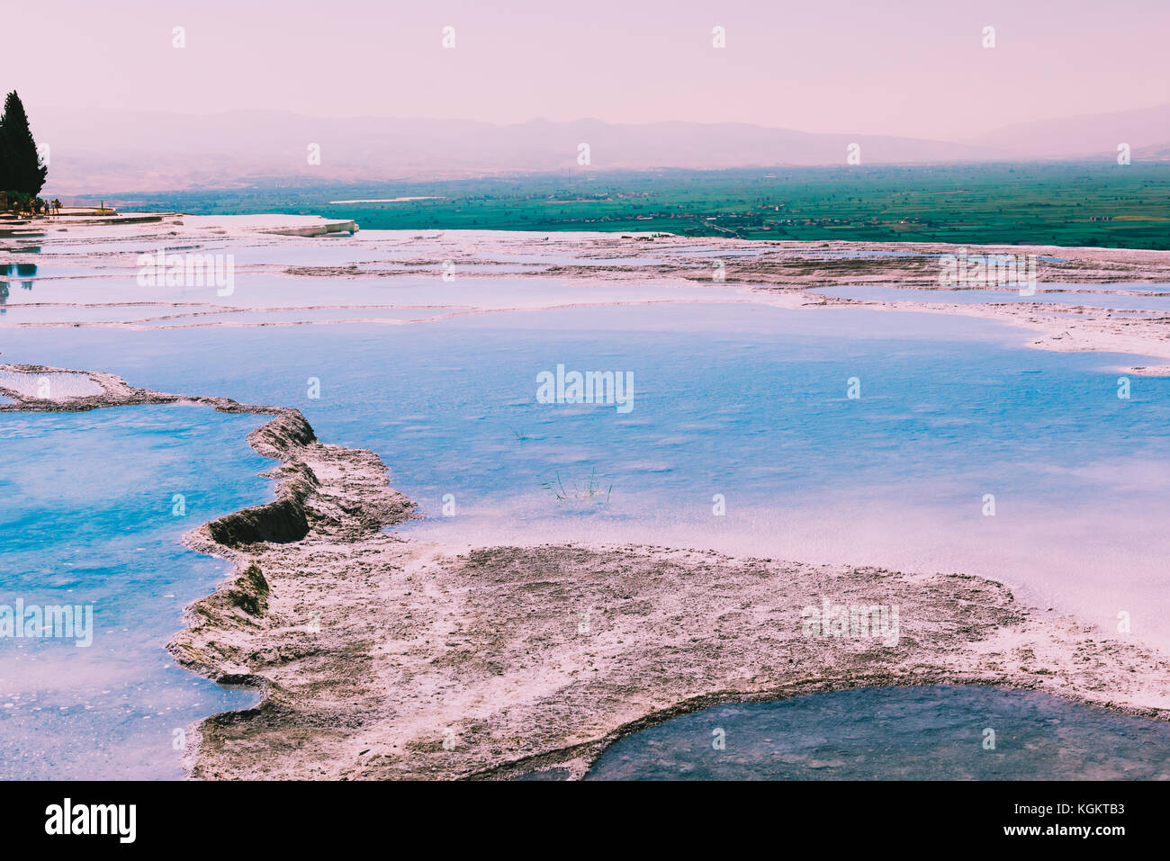 Turquoise color view of Pamukkale (Cotton Castle) is popular with Travertine pools and terraces  where people love to visit in Pamukkale, Turkey. Stock Photo