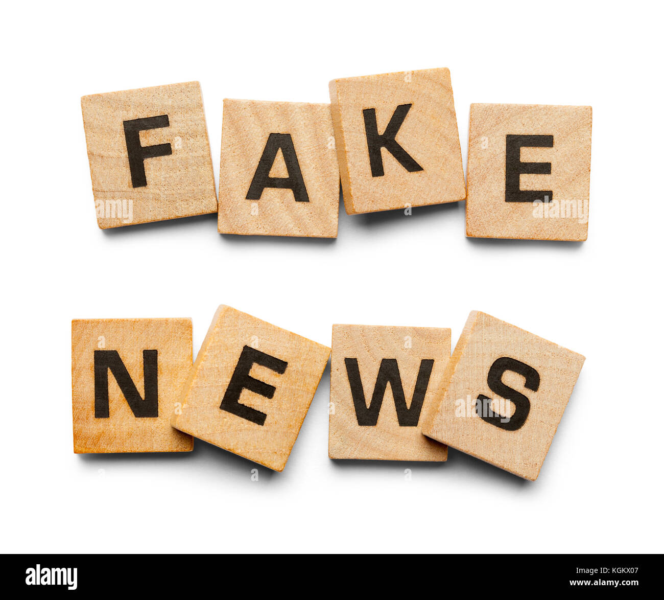 Fake News Spelled with Wood Tiles Isolated on a White Background. Stock Photo