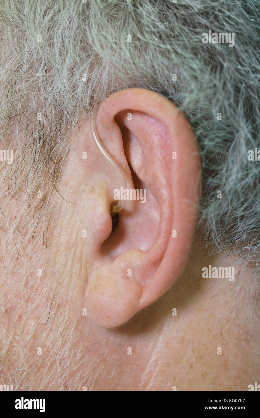 Cropped image of man wearing hearing aid Stock Photo