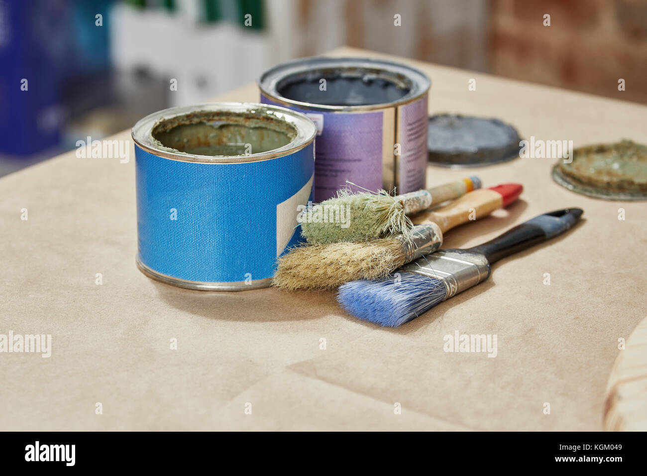 Closeup of paint cans and paintbrushes on workbench Stock Photo Alamy