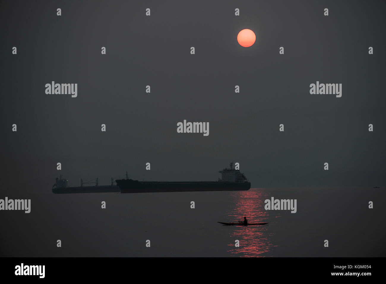 Silhouette freight boats on sea against sky at night Stock Photo - Alamy