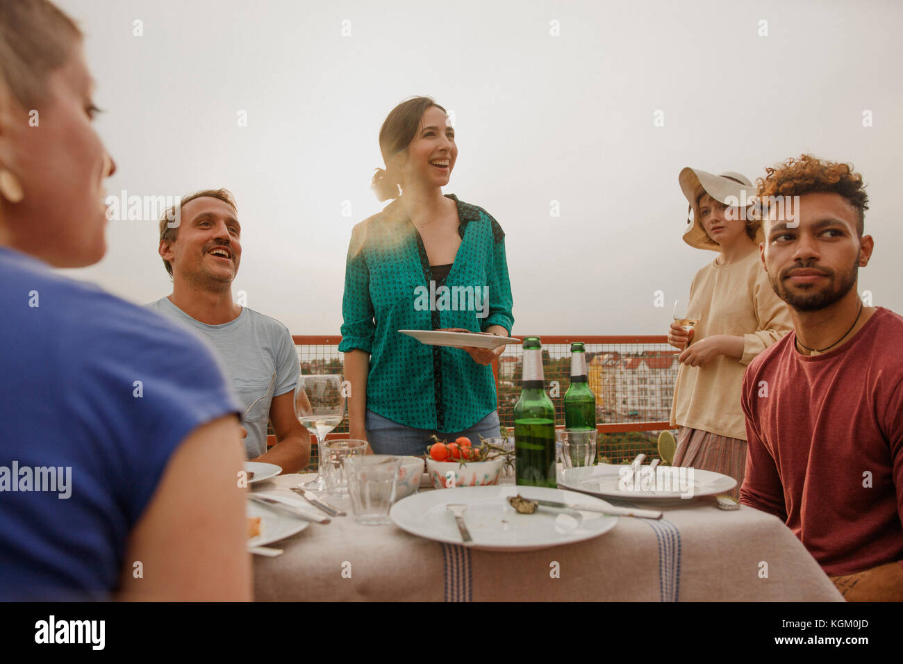 Cheerful friends enjoying lunch party on patio Stock Photo