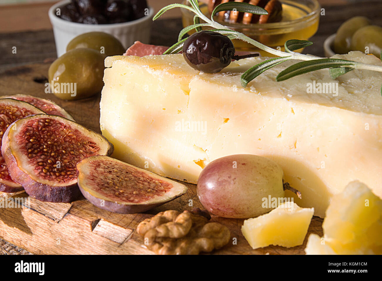 Set of pieces moldy cheese, prosciutto, pickled plums, olives, figs