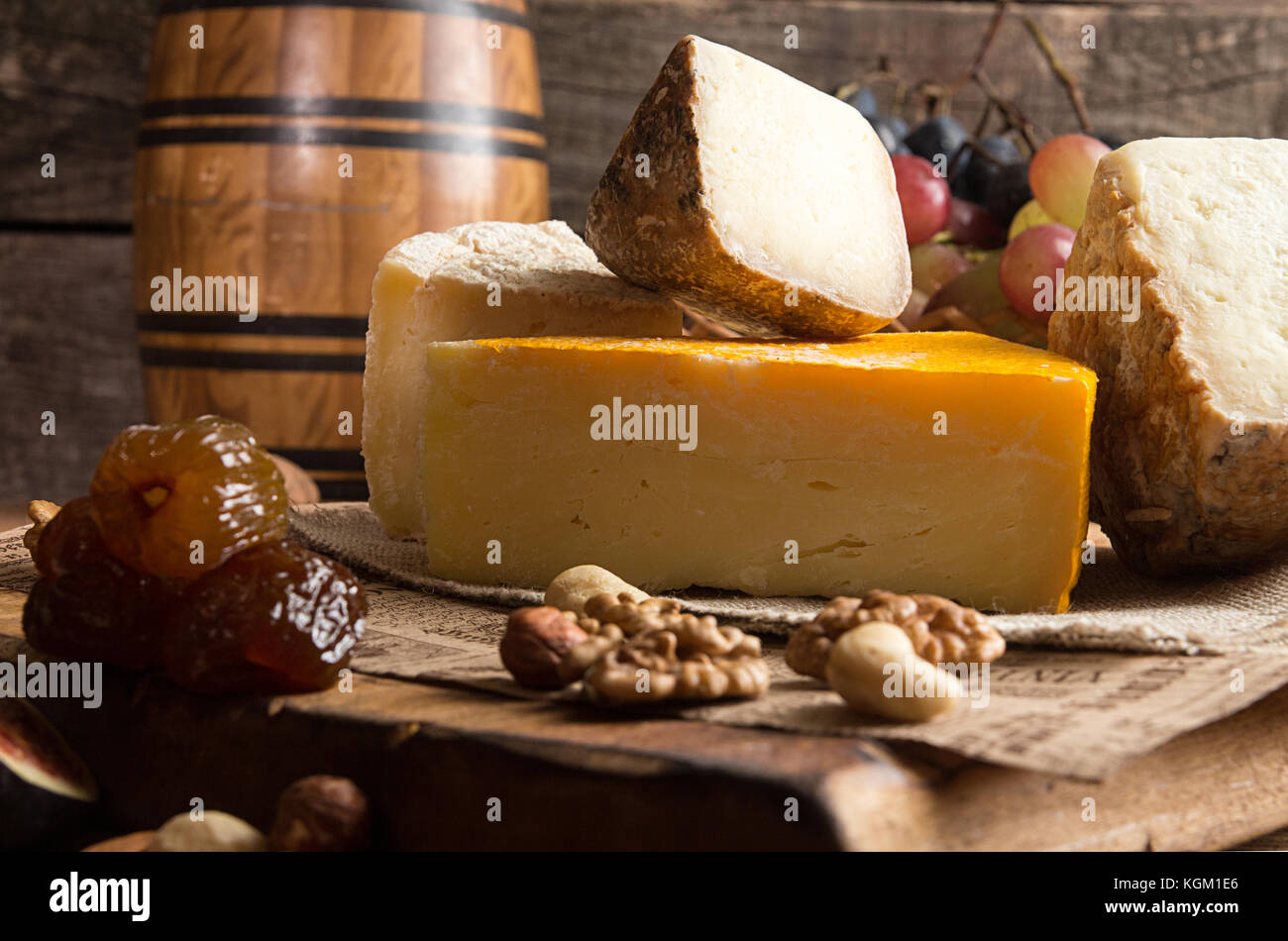 Food composition with blocks of moldy cheese, dried dates, grape bunch