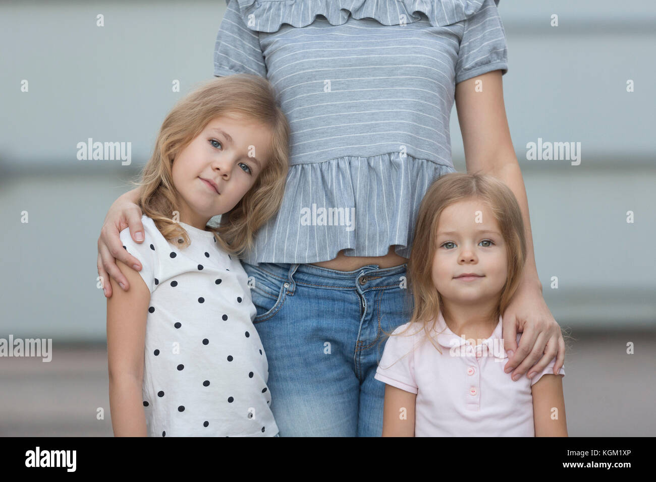 Portrait of girls standing with mother Stock Photo