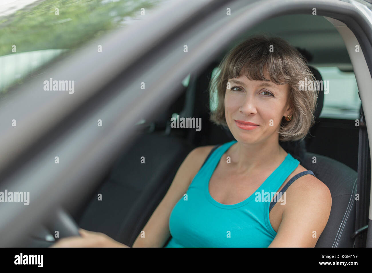 Portrait of smiling mature woman sitting in car Stock Photo