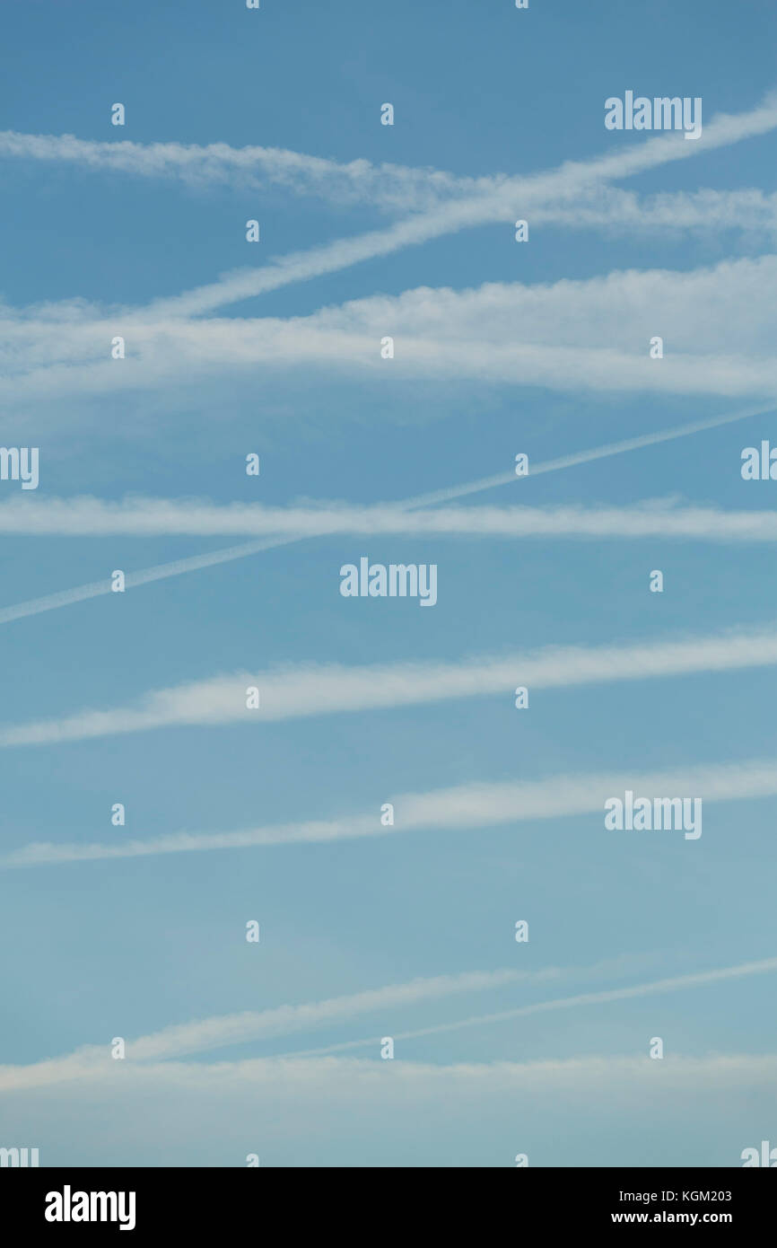 Low angle view of vapor trails in blue sky Stock Photo