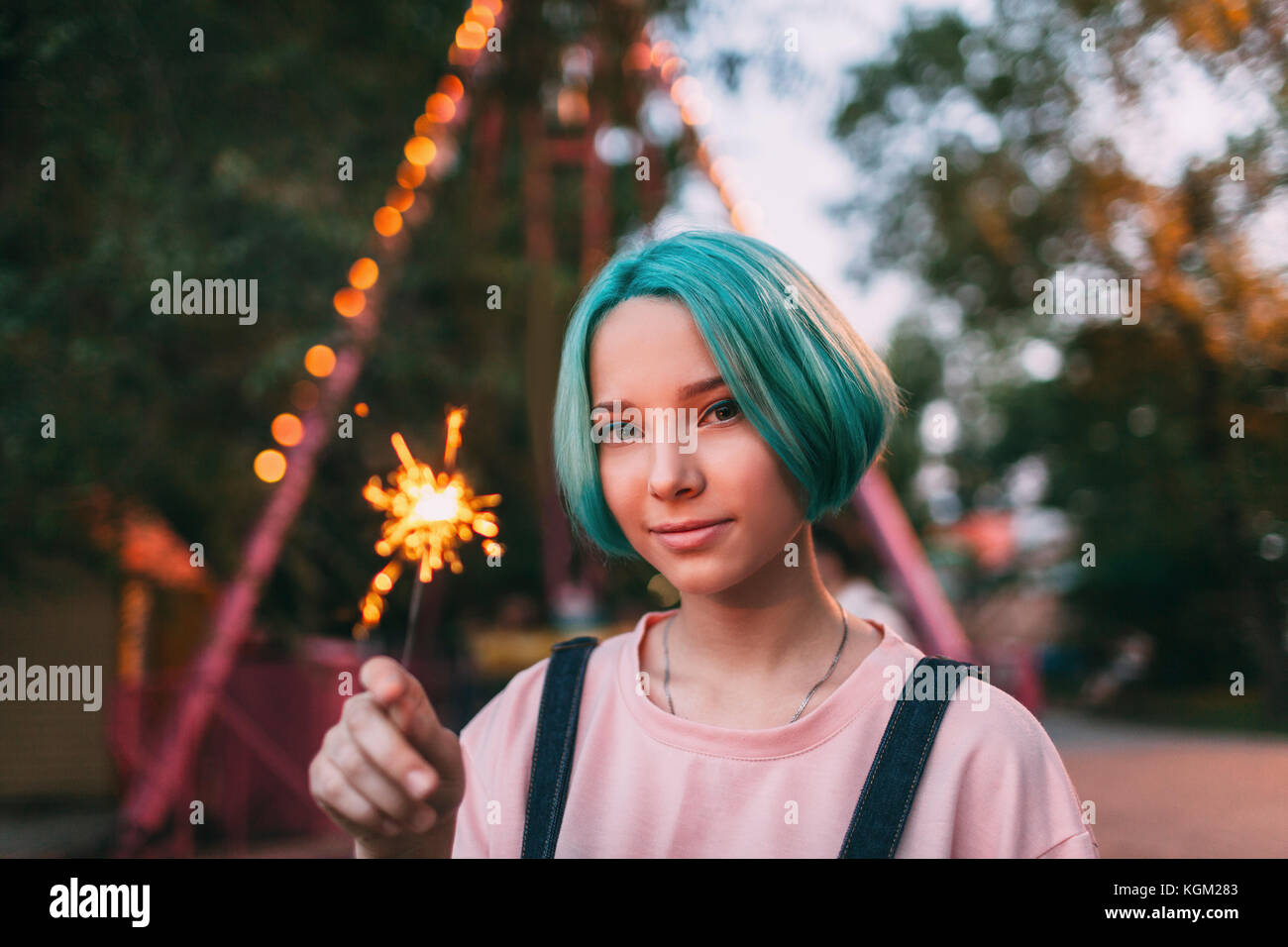 Portrait of teenage girl holding illuminated sparkler Stock Photo
