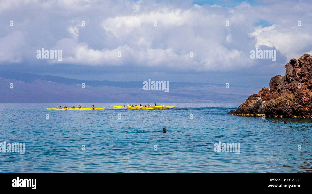 Outrigger canoes, swimmer and snorkelers by Black Rock at Kaanapali Beach in Kaanapali, Maui Stock Photo