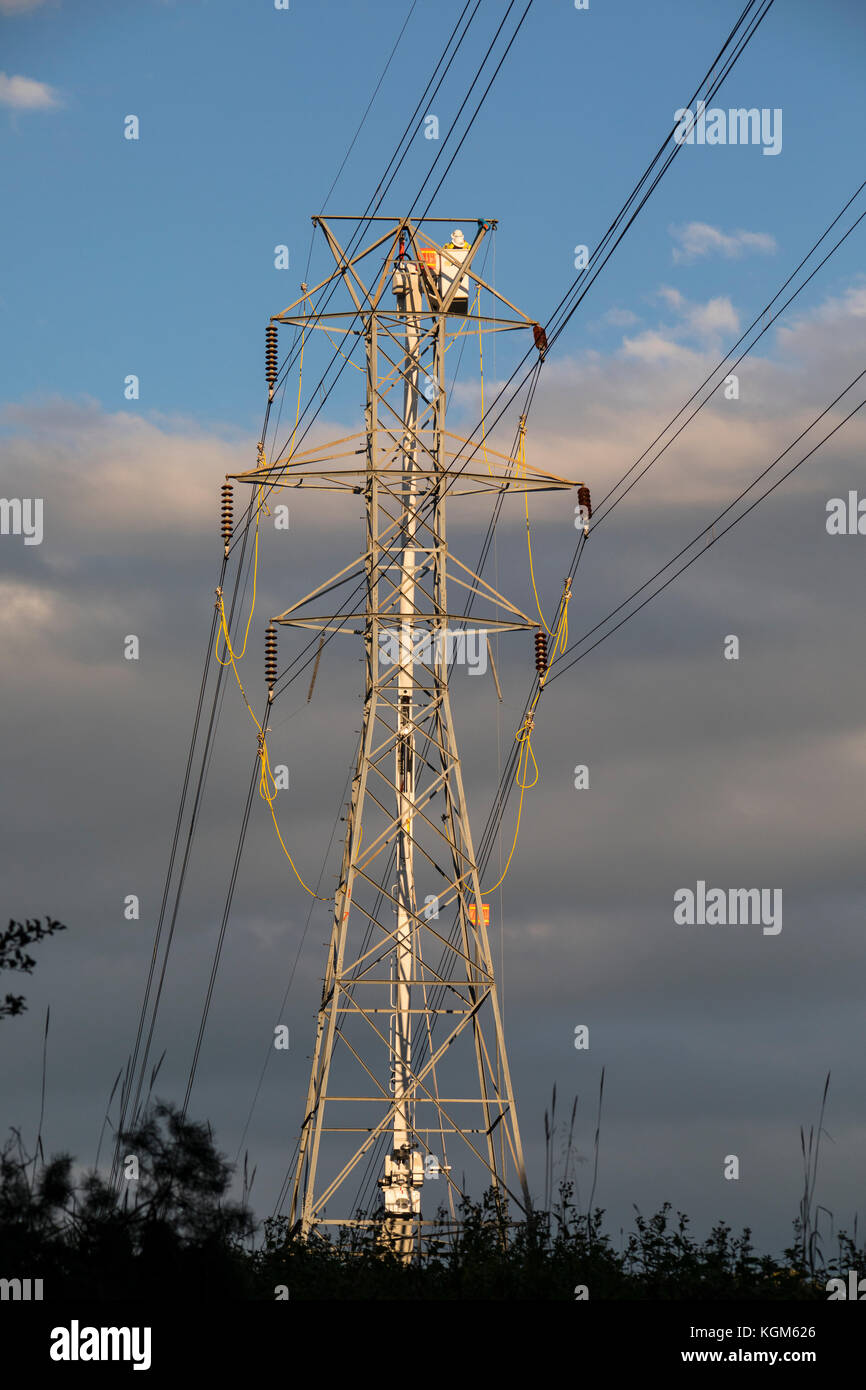 Electric company linemen work on transmission lines repairing wind storm and tornado damage