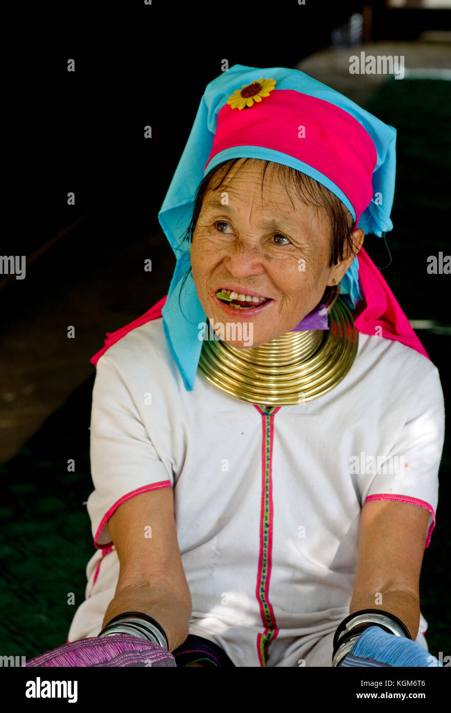 Longneck Kayan women sitting with brass collar rings around her neck Stock Photo