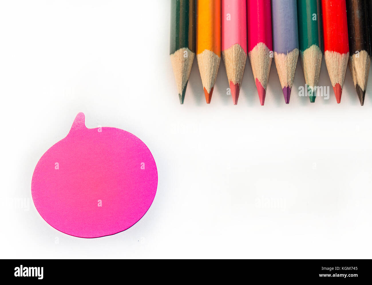 Colored Pencils and single Sticky Note on white background Stock Photo ...
