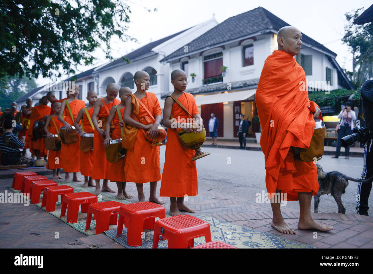 Monks walking along street in luang prabang hi-res stock photography ...