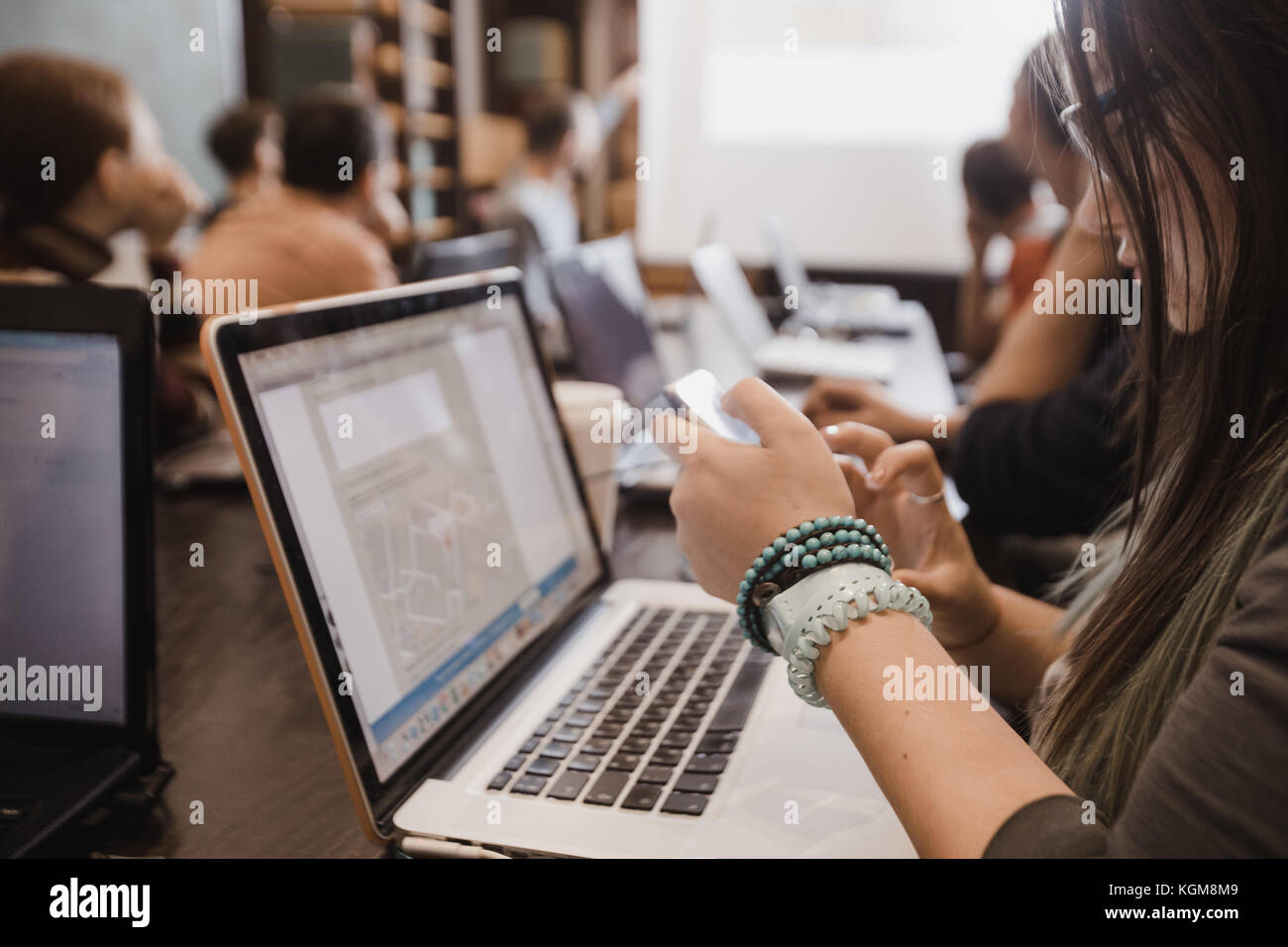 Students in classroom working with laptops Stock Photo