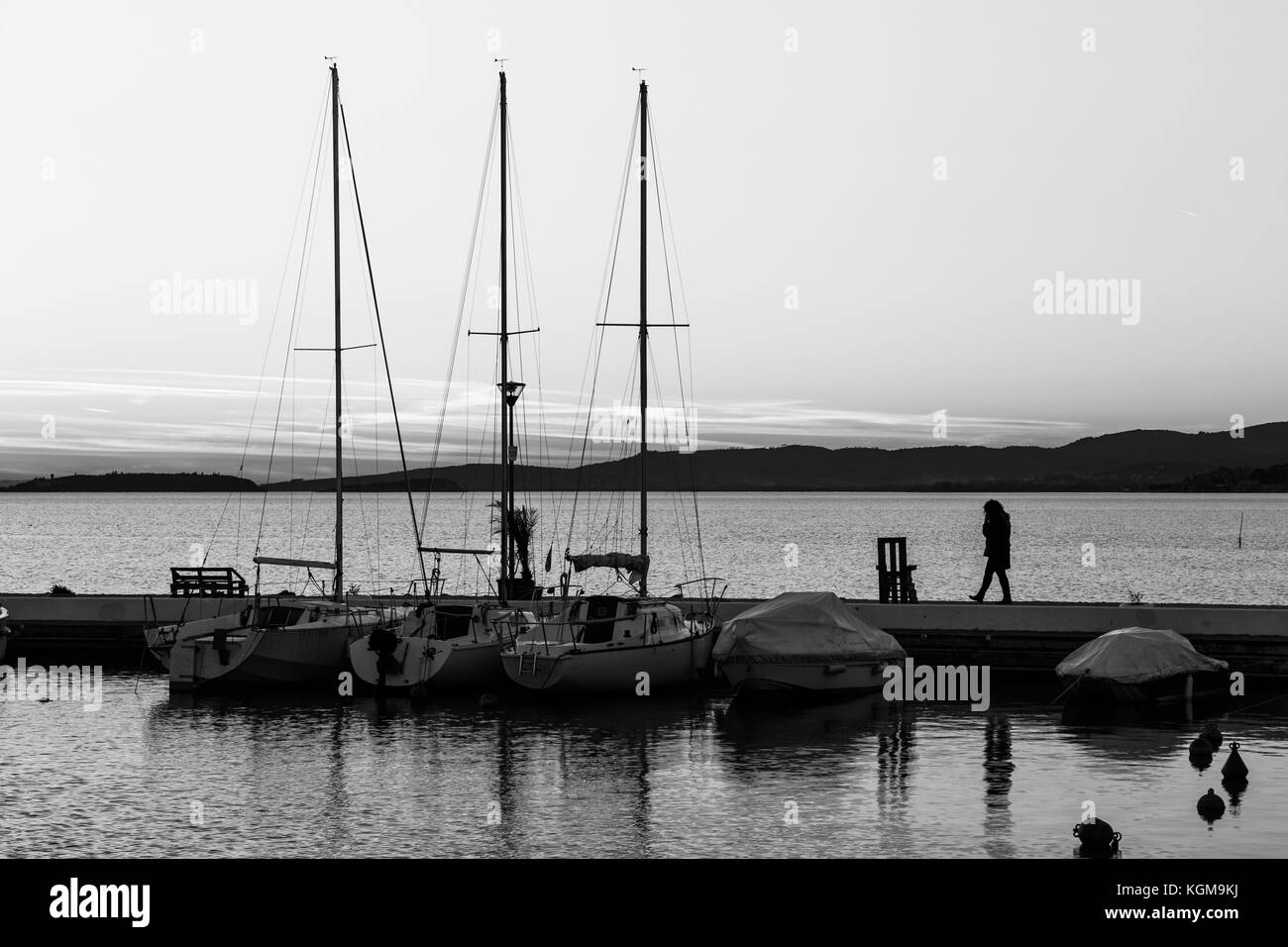 Silhouette woman on dock sunset hi-res stock photography and images - Alamy