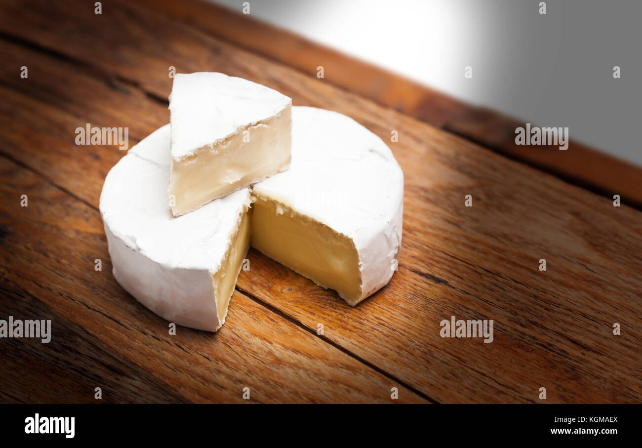 French Camembert cheese on rustic wooden table background Stock Photo