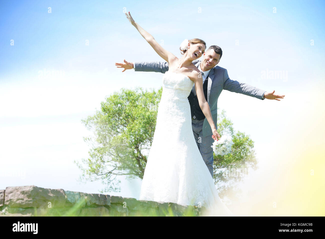 Bride and groom having fun walking in parapet Stock Photo Alamy