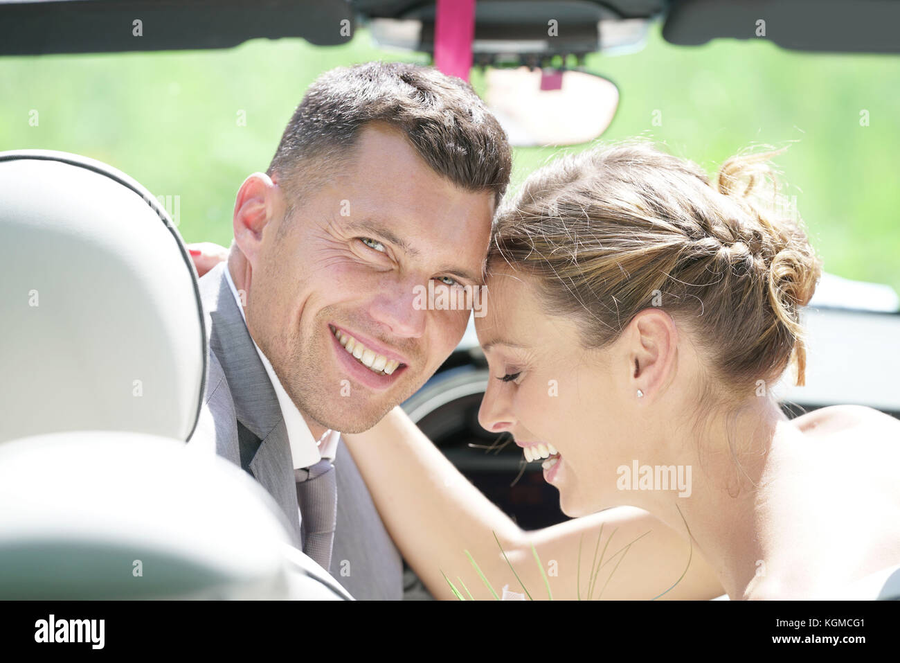 Bride and groom sitting in convertible car Stock Photo - Alamy