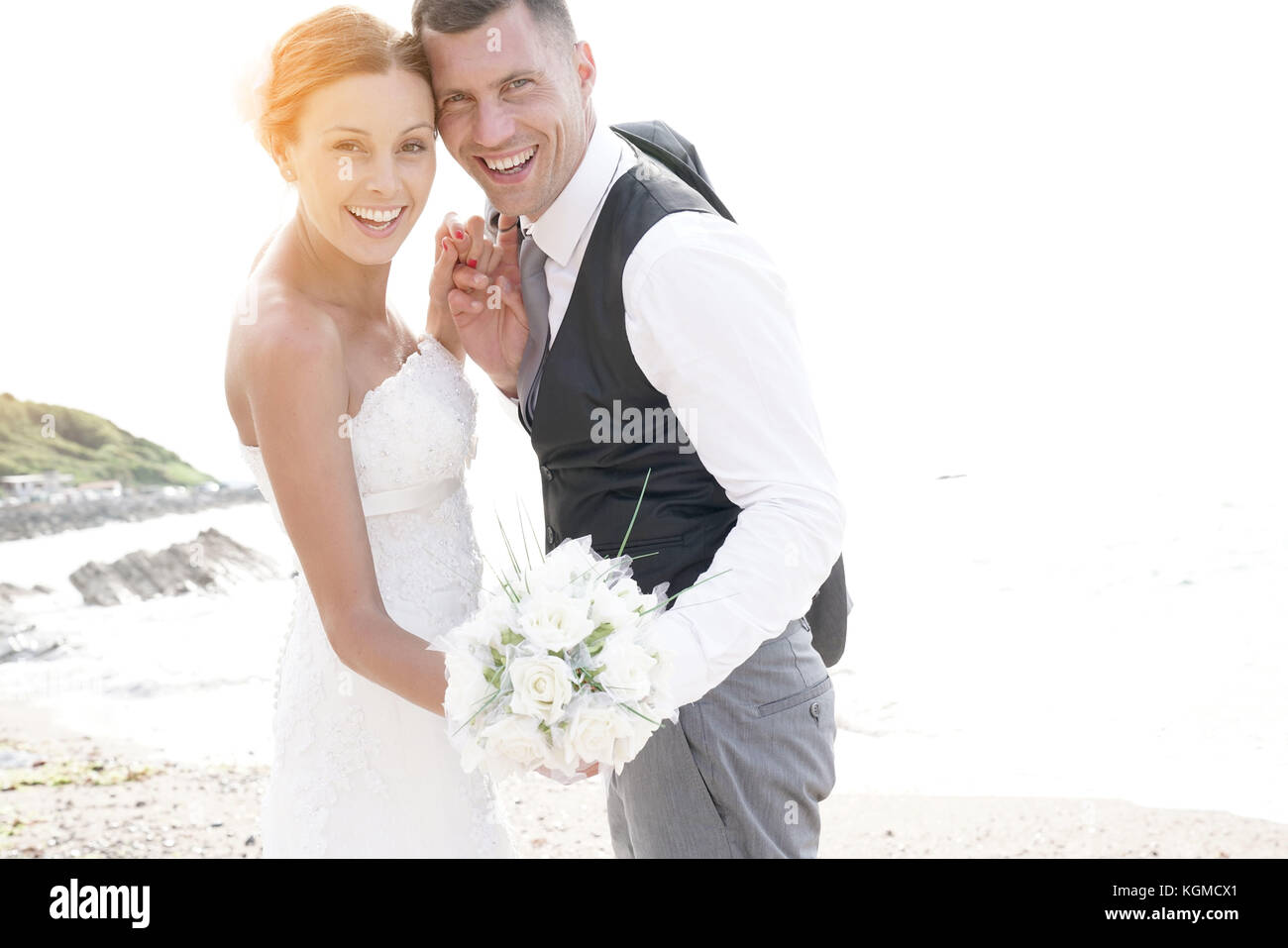 happy bride and groom on the beach at sunset Stock Photo - Alamy