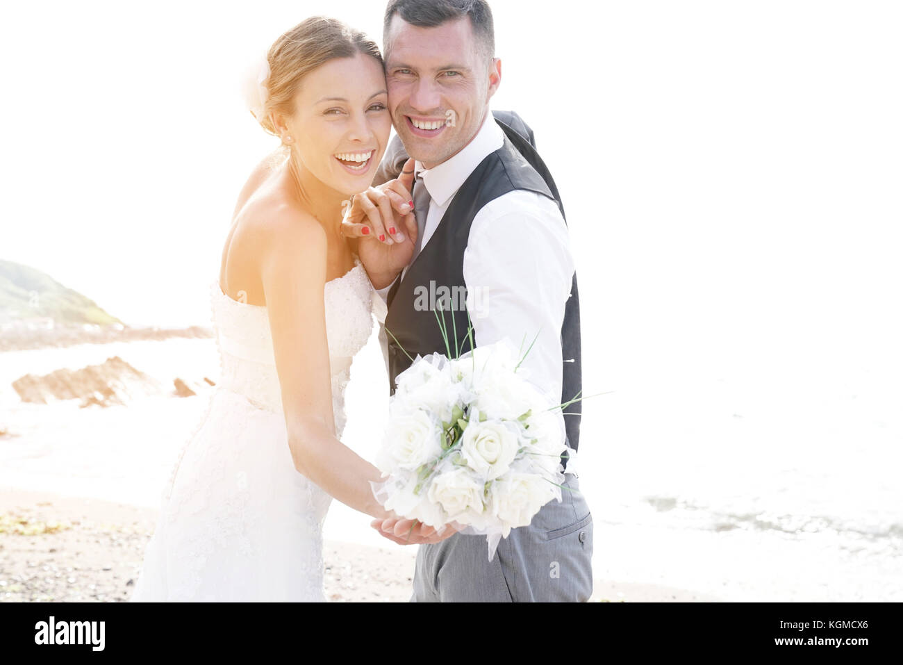 happy bride and groom on the beach at sunset Stock Photo - Alamy