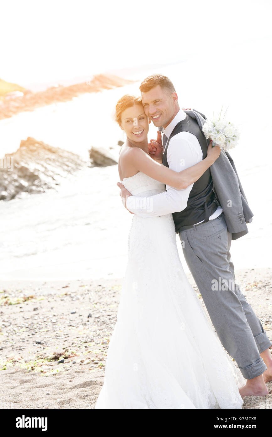 happy bride and groom on the beach at sunset Stock Photo - Alamy