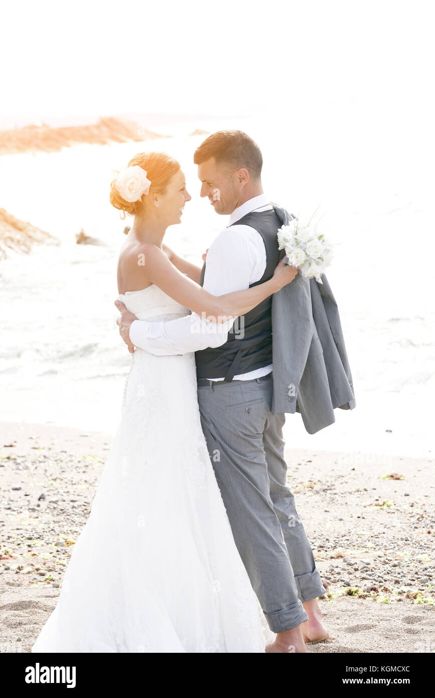 happy bride and groom on the beach at sunset Stock Photo - Alamy