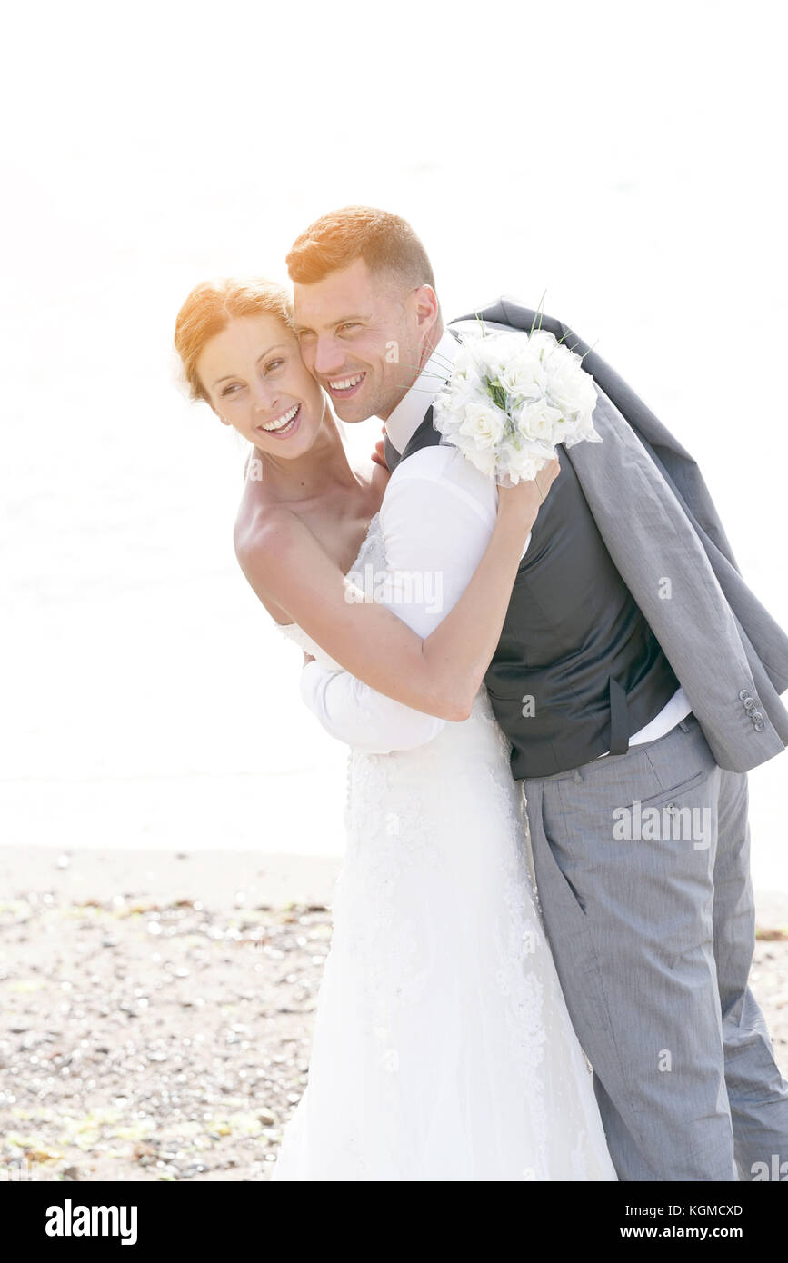 happy bride and groom on the beach at sunset Stock Photo - Alamy