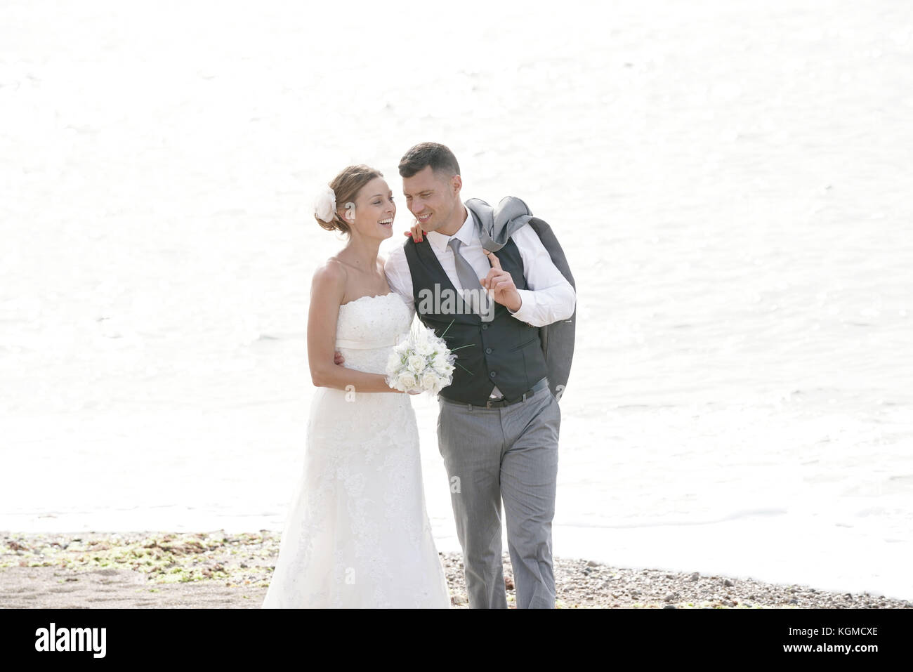 happy bride and groom on the beach at sunset Stock Photo - Alamy