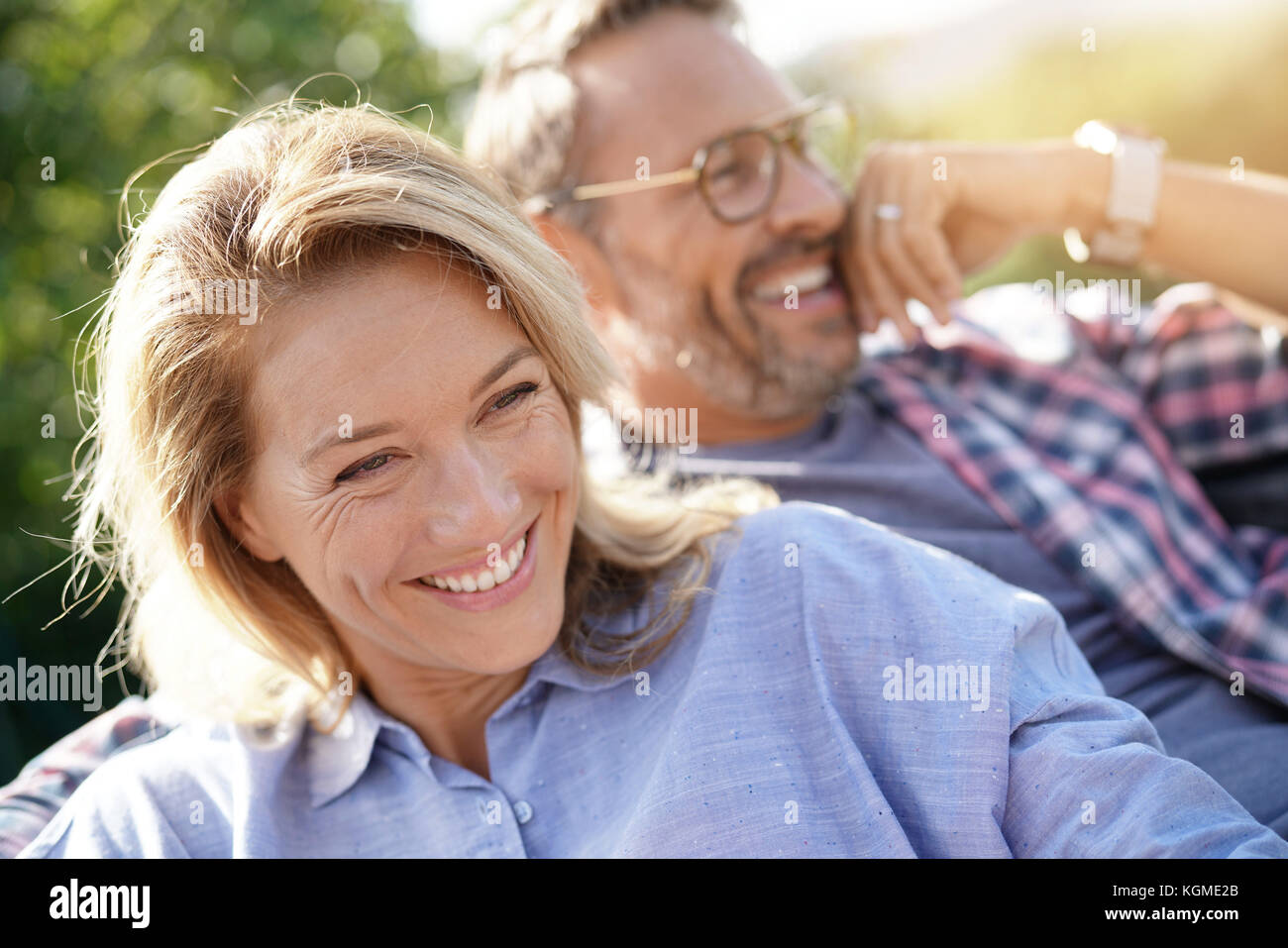 Portrait of mature couple relaxing in outdoor sofa Stock Photo