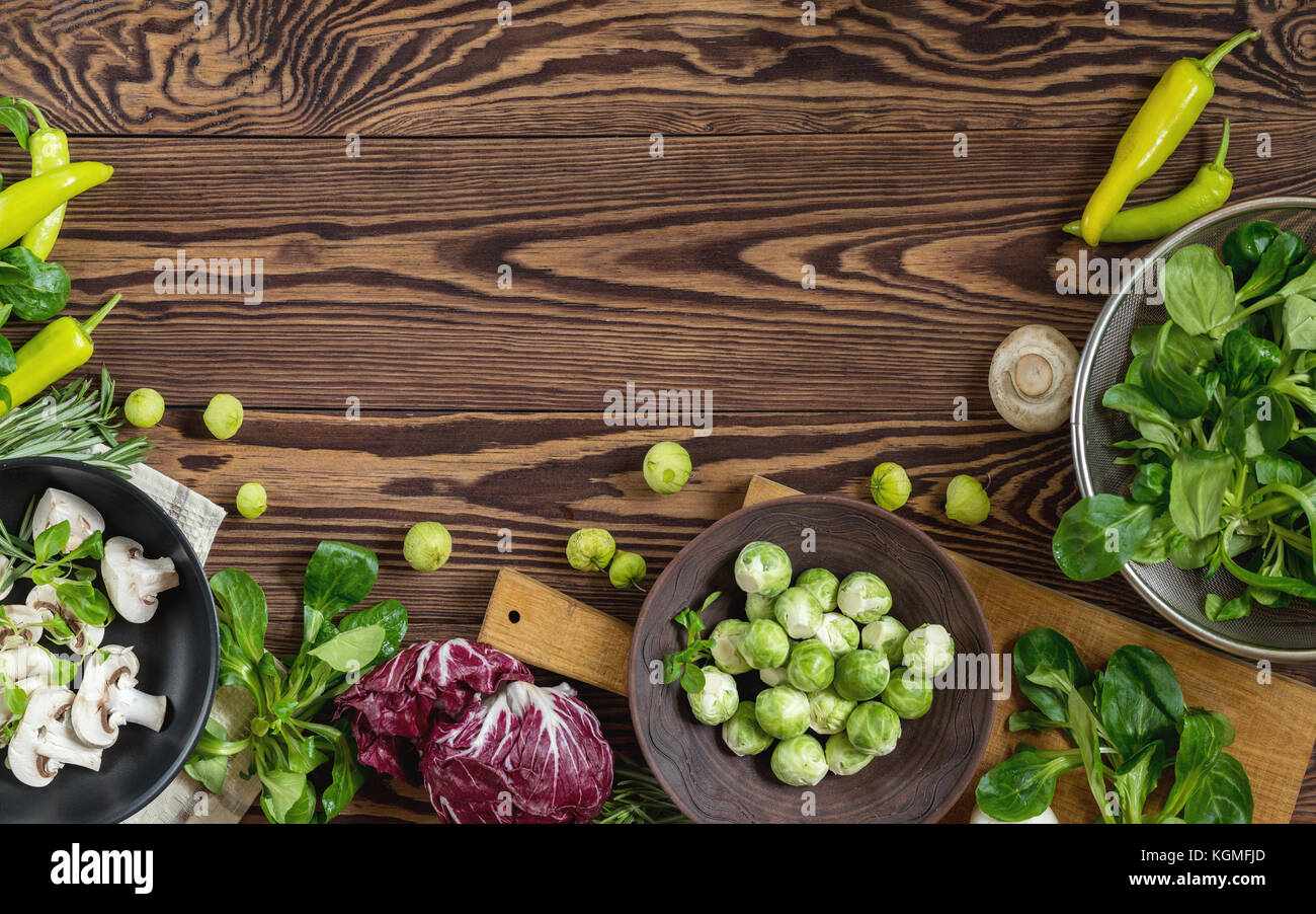 Fresh organic vegetables from the garden on wooden background. Top view ...