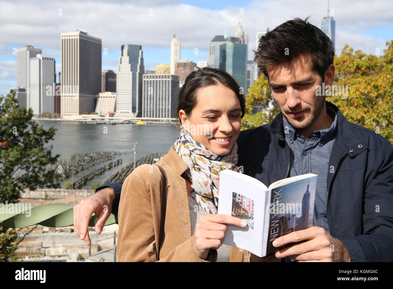 Couple of tourists reading New York city guide Stock Photo Alamy