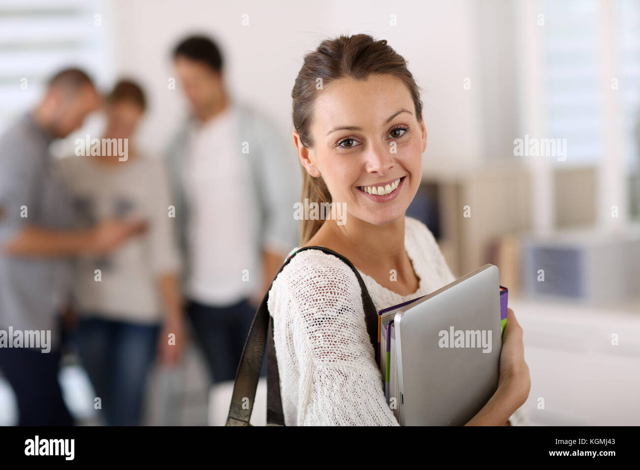 College girl holding books and going to class Stock Photo - Alamy