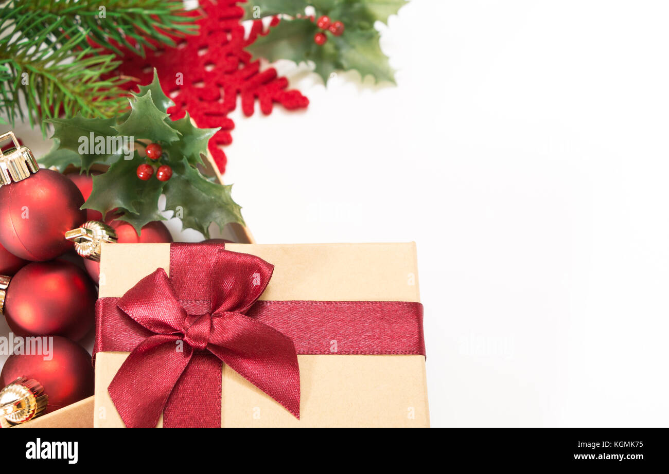 Paper gift box with a red bow and Christmas balls, on white background ...