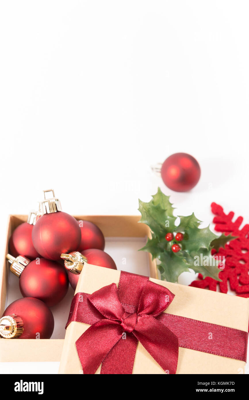 Paper gift box with a red bow and Christmas balls, on white background ...