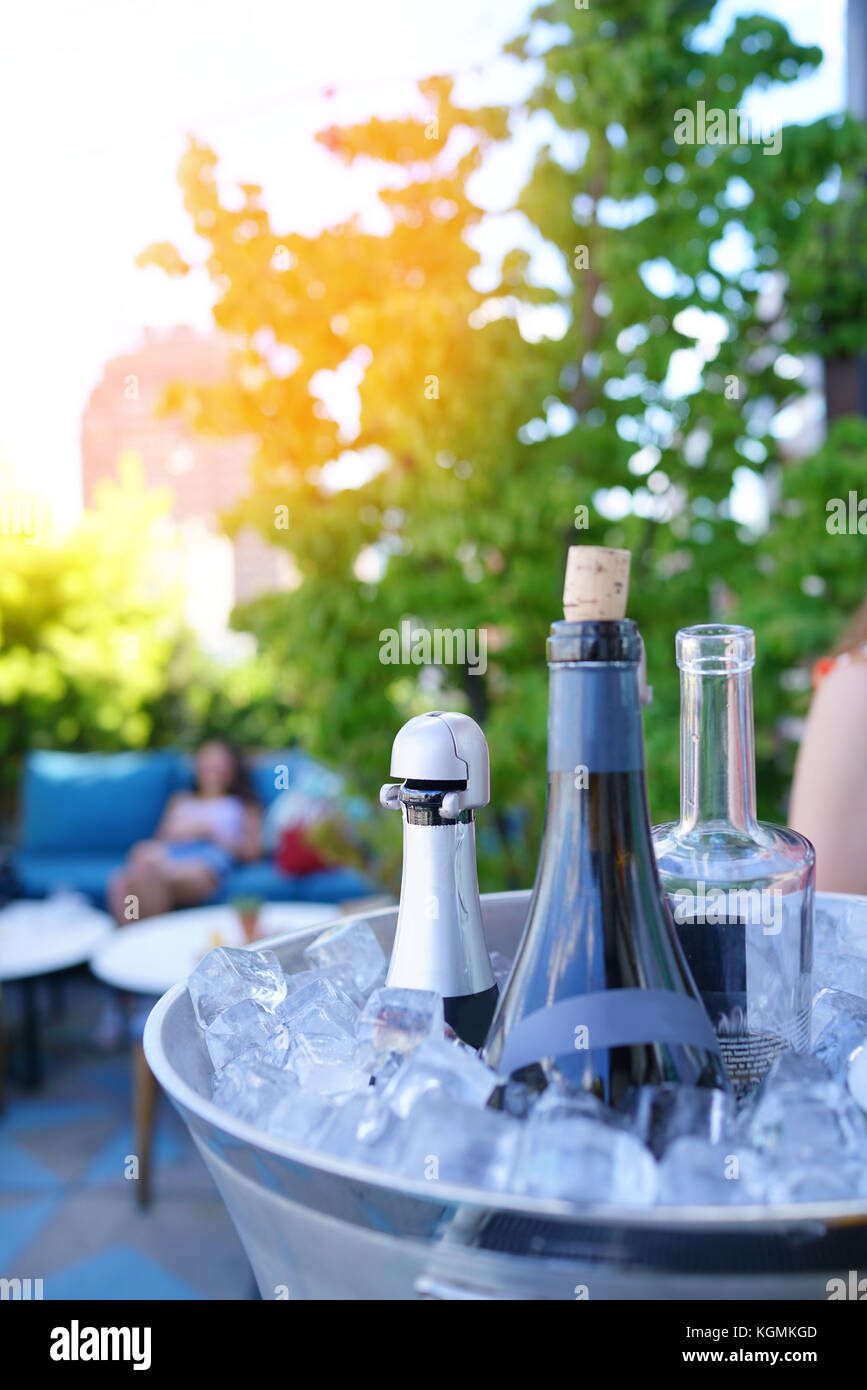 Wine bottles set in bucket, NYC rooftop Stock Photo Alamy