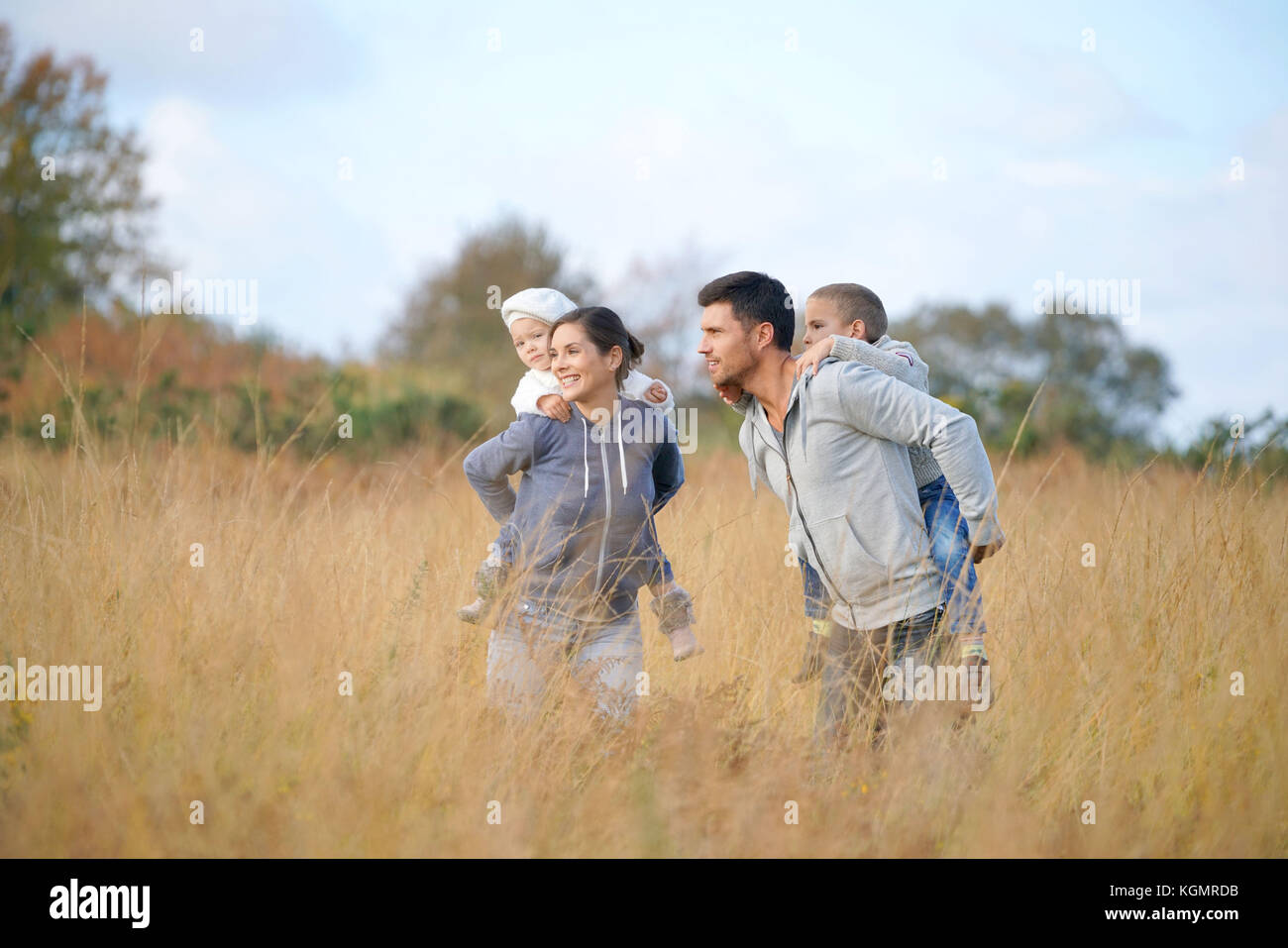 Happy family enjoying fall day in the countryside Stock Photo - Alamy