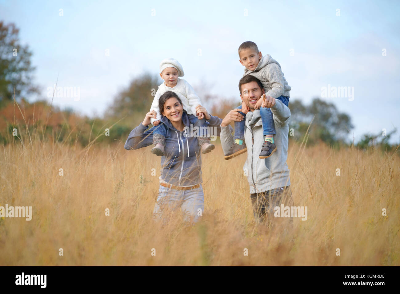 Happy family enjoying fall day in the countryside Stock Photo - Alamy