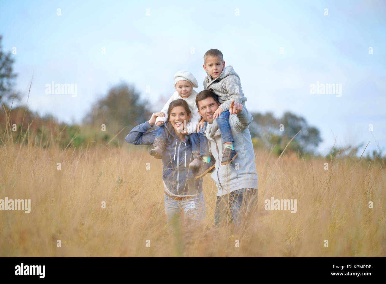 Happy family enjoying fall day in the countryside Stock Photo - Alamy