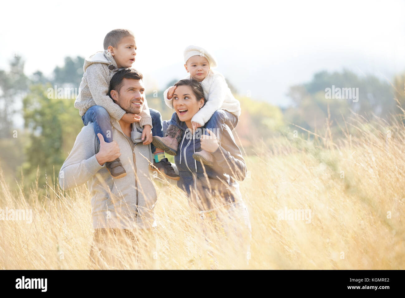 Happy family enjoying fall day in the countryside Stock Photo - Alamy