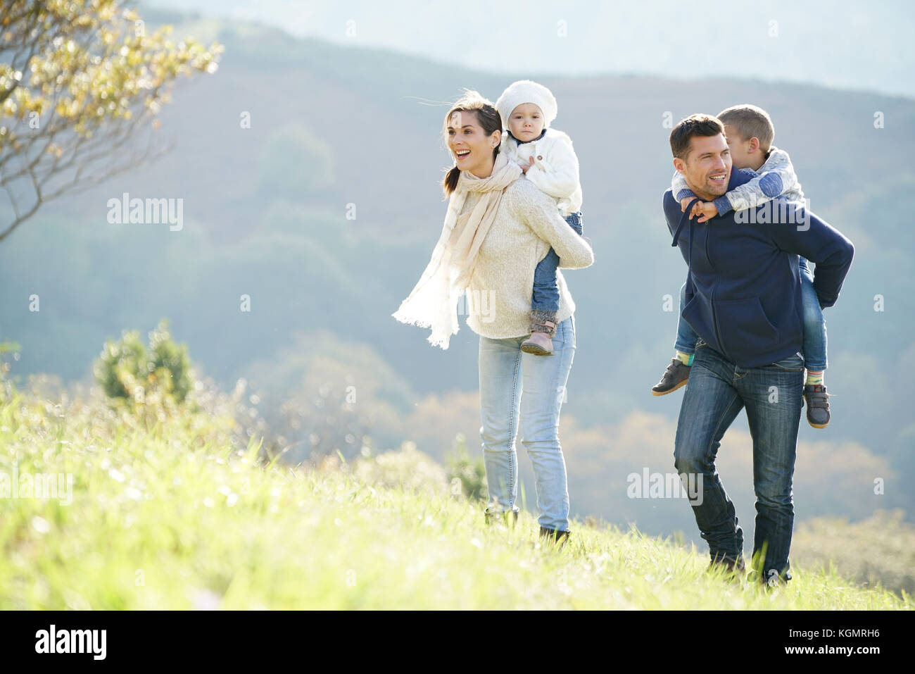 Happy family walking in countryside on autumnal week-end Stock Photo