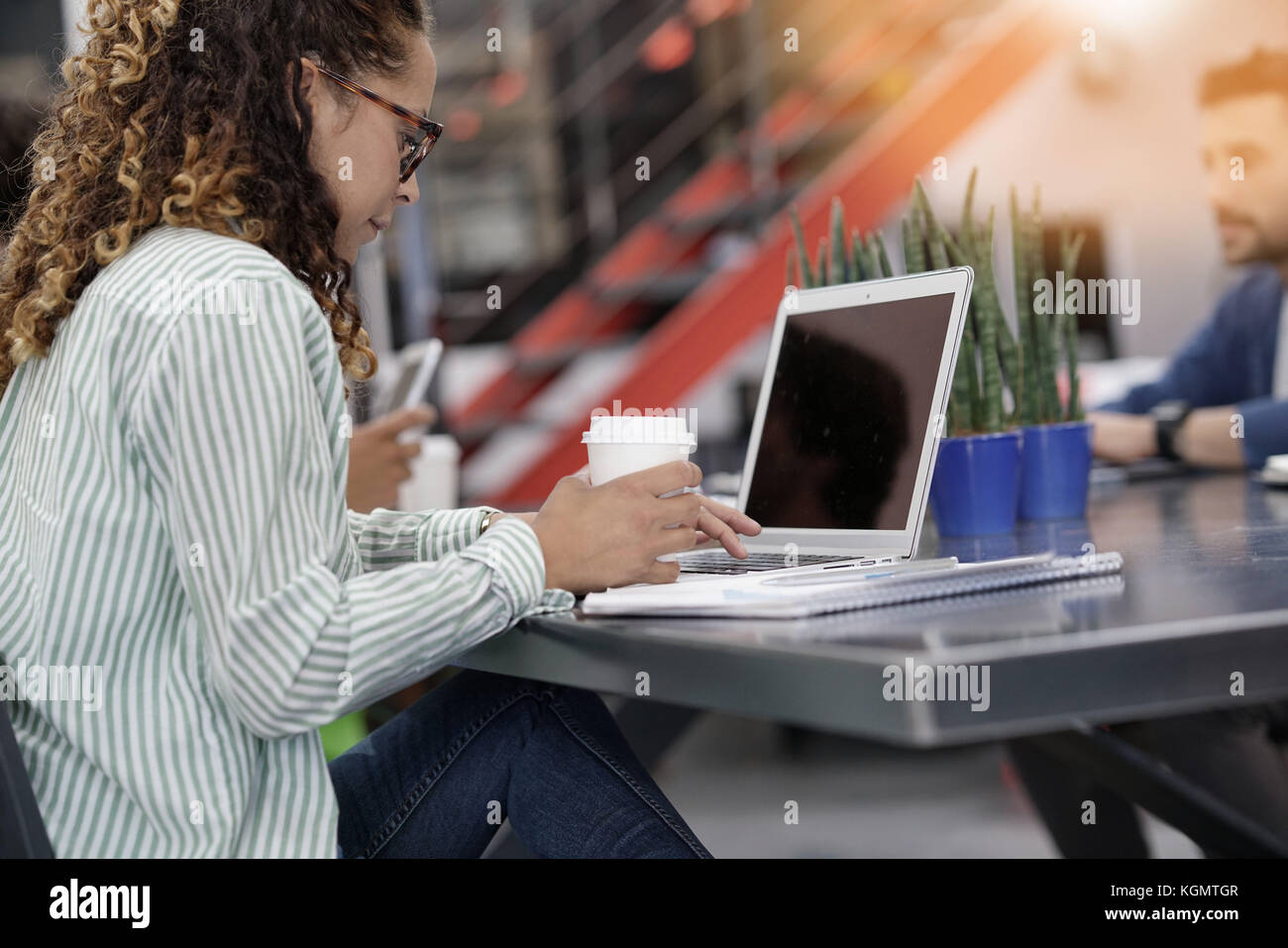 Young startup entrepreneur in office working on laptop Stock Photo - Alamy