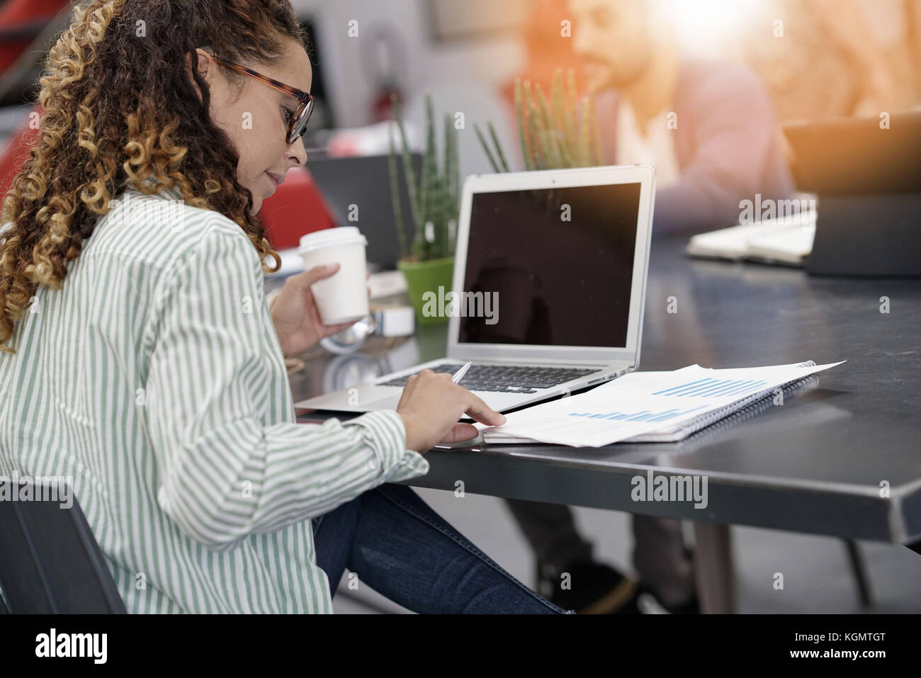 Young startup entrepreneur in office working on laptop Stock Photo - Alamy