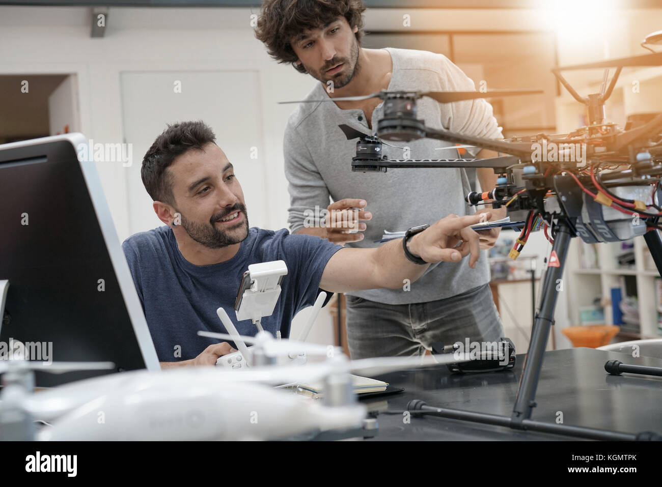 Engineer and technician working together on drone in office Stock Photo ...