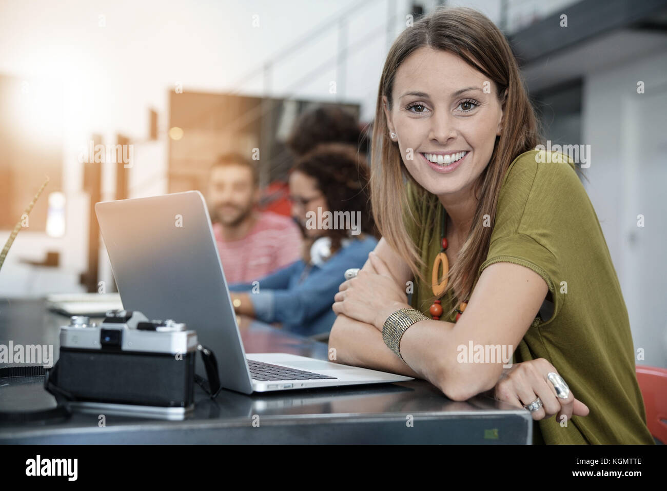 Young woman working in open space office Stock Photo - Alamy