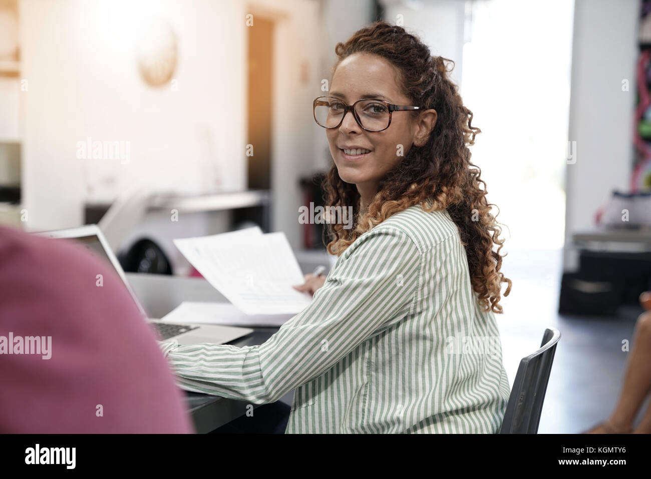 Young woman working in open space office Stock Photo - Alamy