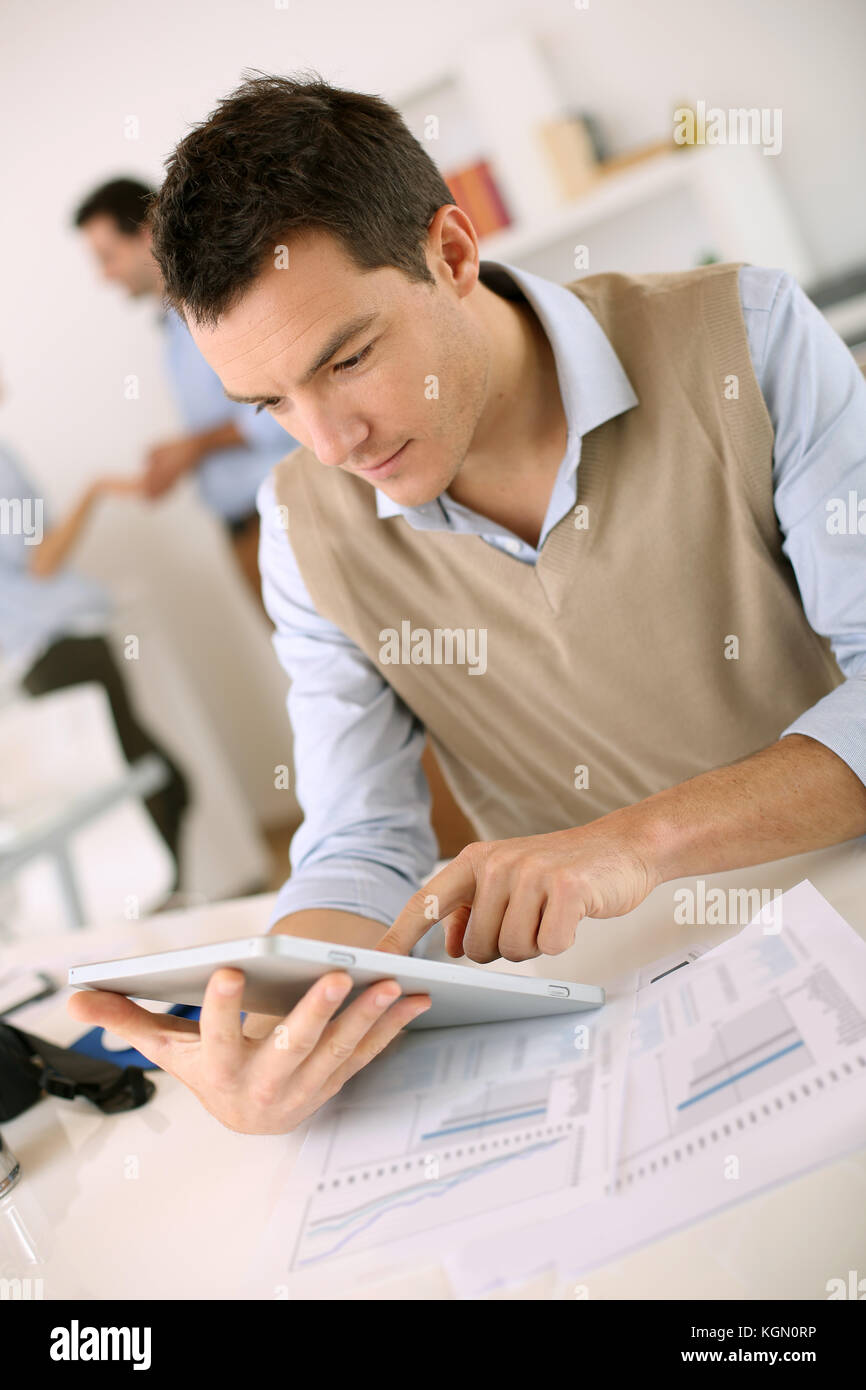 Handsome guy working with tablet in office Stock Photo