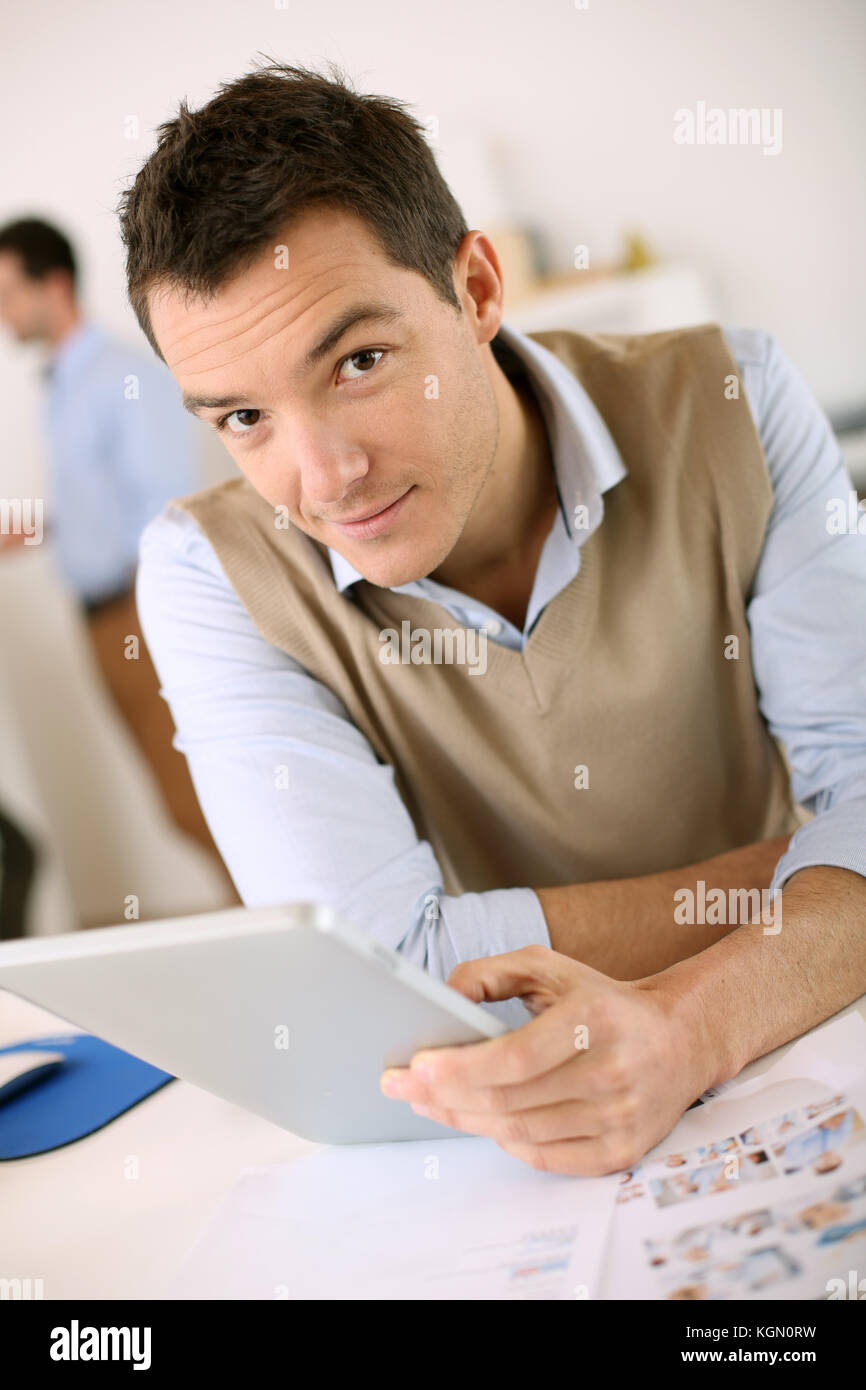 Handsome guy working with tablet in office Stock Photo
